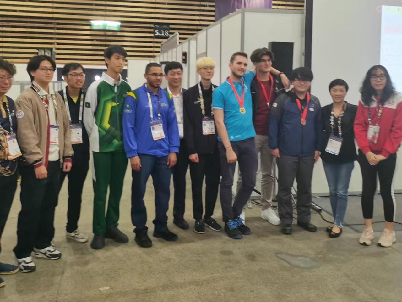 A group of competitors standing in a row at WorldSkills Lyon 2024. 

